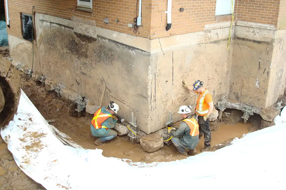 Workers repairing foundation